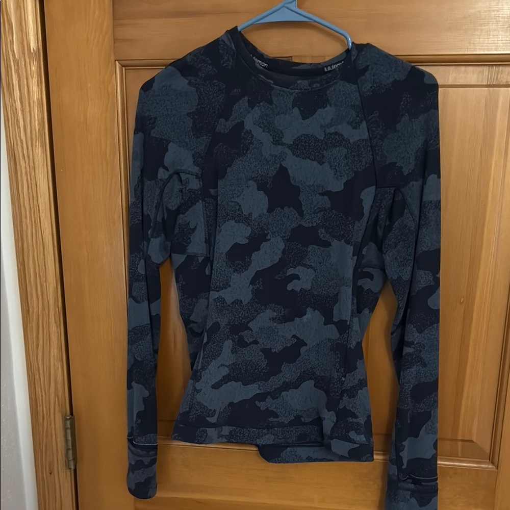 Black and Gray Camouflage Long Sleeve Lululemon pullover. 1 zip pocket at hip.